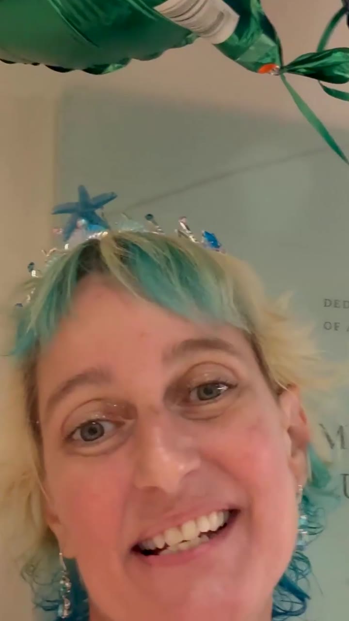 Danell smiling in a tiara on the transplant unit, one year after her stem cell transplant